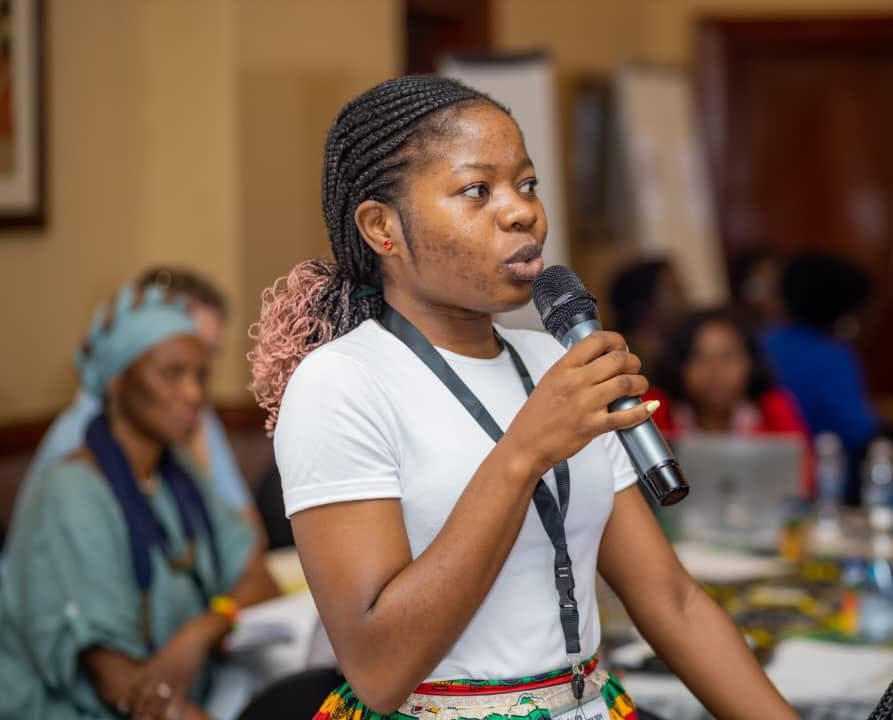 South Seventeen facilitator speaking into a microphone during a live session.