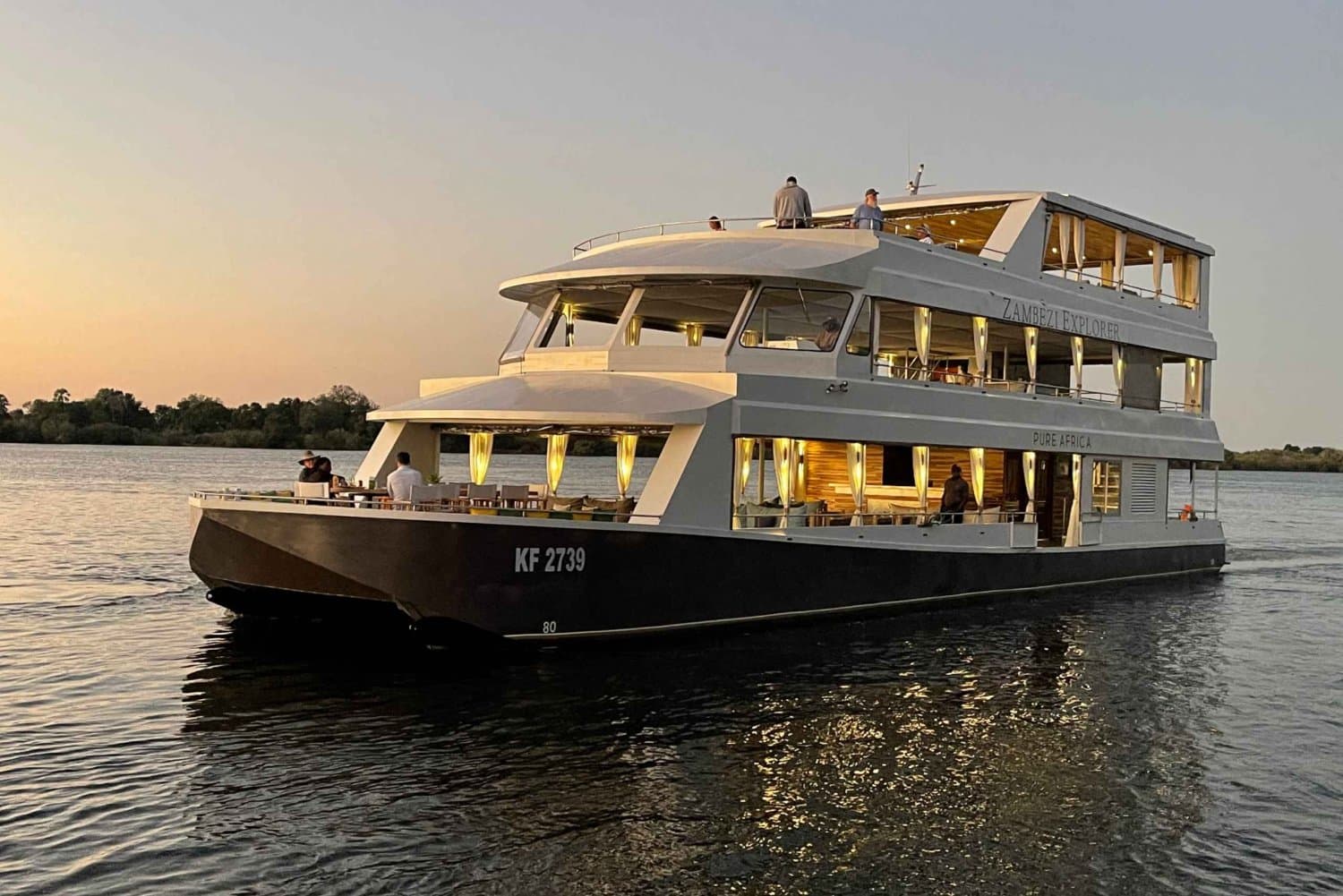 The Zambezi Explorer luxury cruise boat at golden sunset on the Zambezi River.